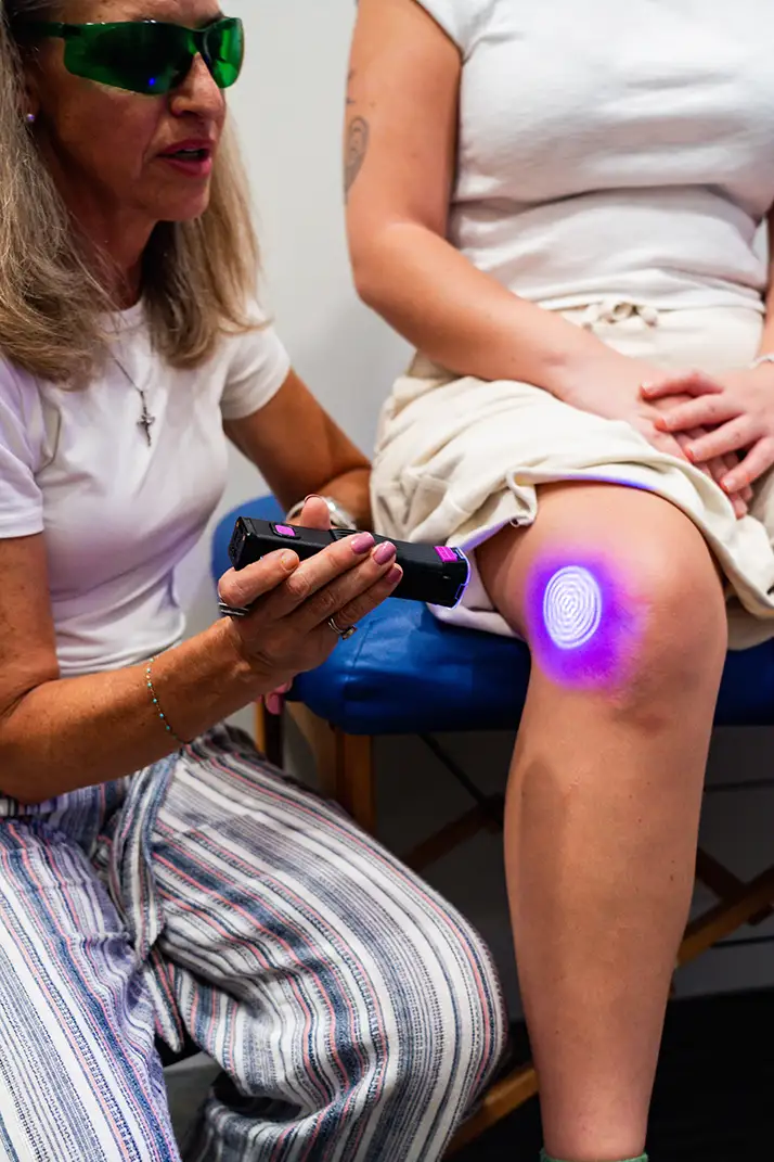 Chiropractic St. Augustine FL Laser Therapy Cold Laser therapy on a patients knee.